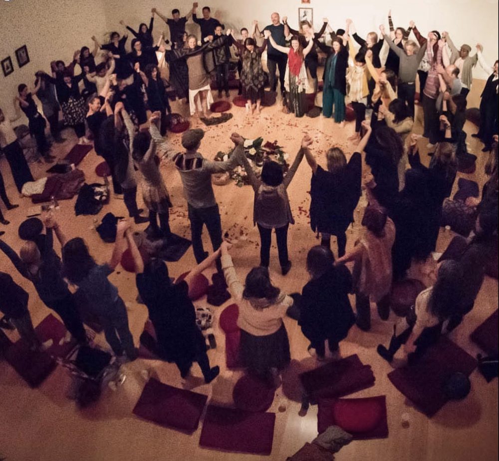 A circle with arms raised together